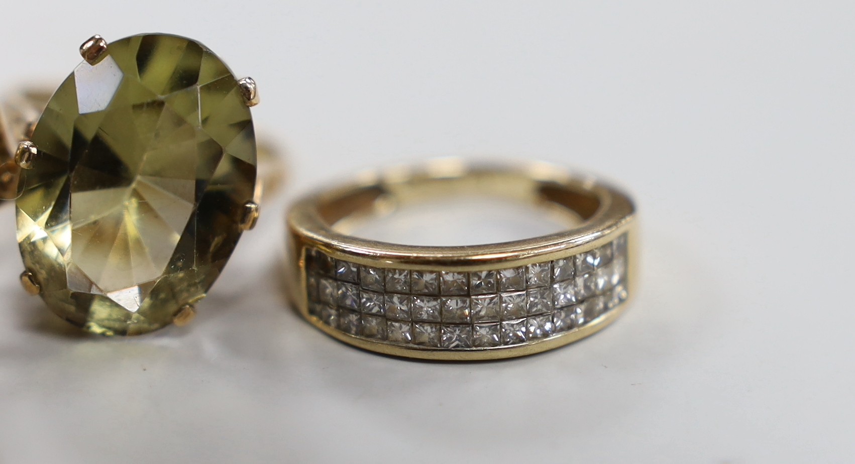 Three 9ct gold and gem set rings, gross 13.4 grams, a 9ct gold cross and one other yellow metal ring.